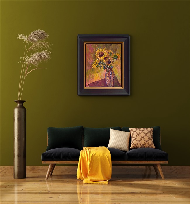 Painting of sunflowers by impressionist painter Erin Hanson hanging in a home on a green painted wall.