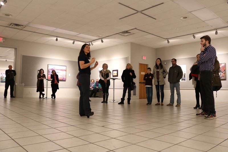 Erin Hanson speaking at an exhibition 2/7